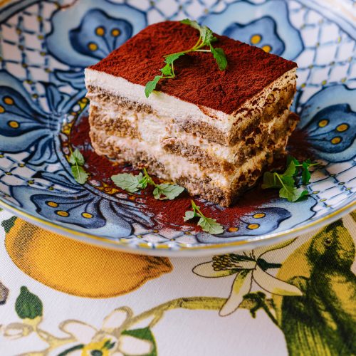 Piece of traditional italian Tiramisu dessert cake